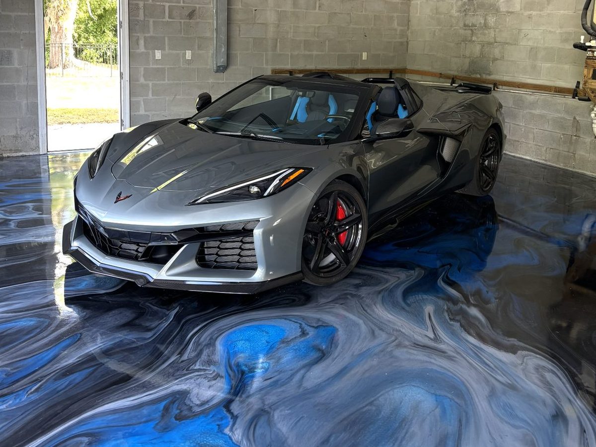 Corvette parked on a blue metallic epoxy garage floor