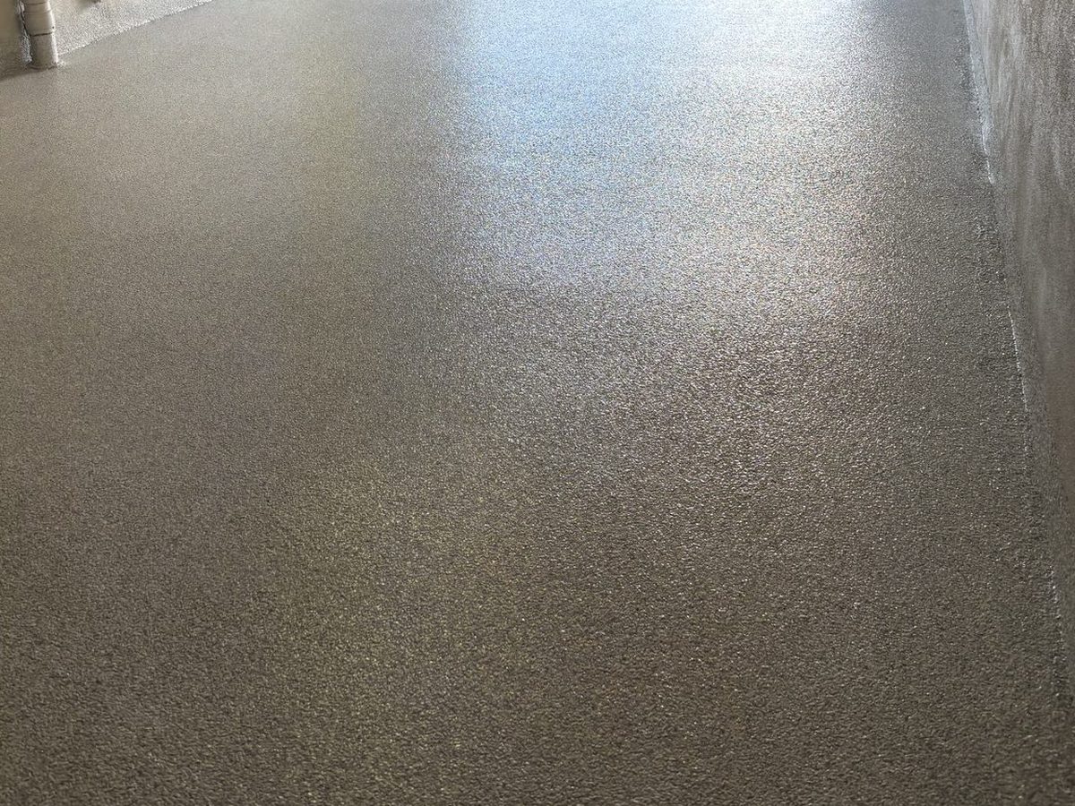 Grey flake epoxy garage floor with a truck outside